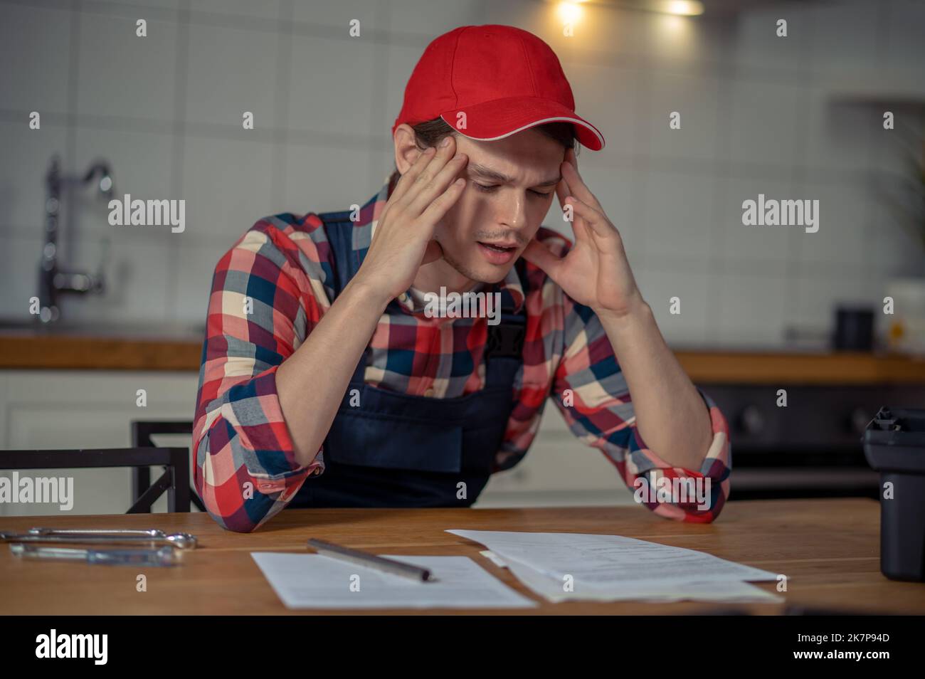 Concentrated serviceman perusing technical documentation before work Stock Photo