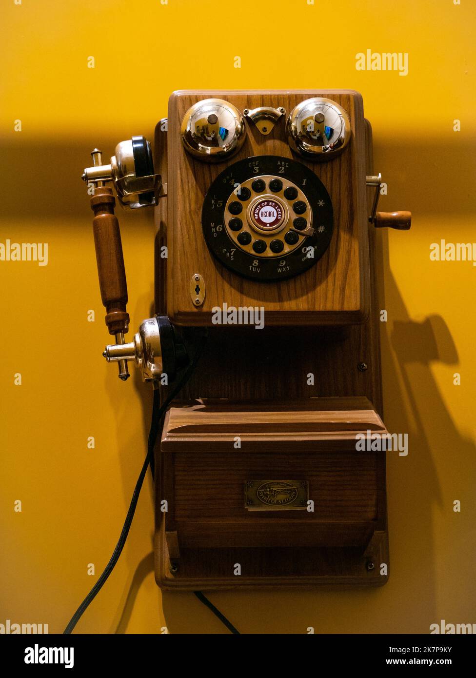 Jerico, Antioquia, Colombia - April 5 2022: Touch-Tone Bronze Wood Telephone, Vintage Redial Spirit in the Museum of Anthropology and Arts Exhibition Stock Photo