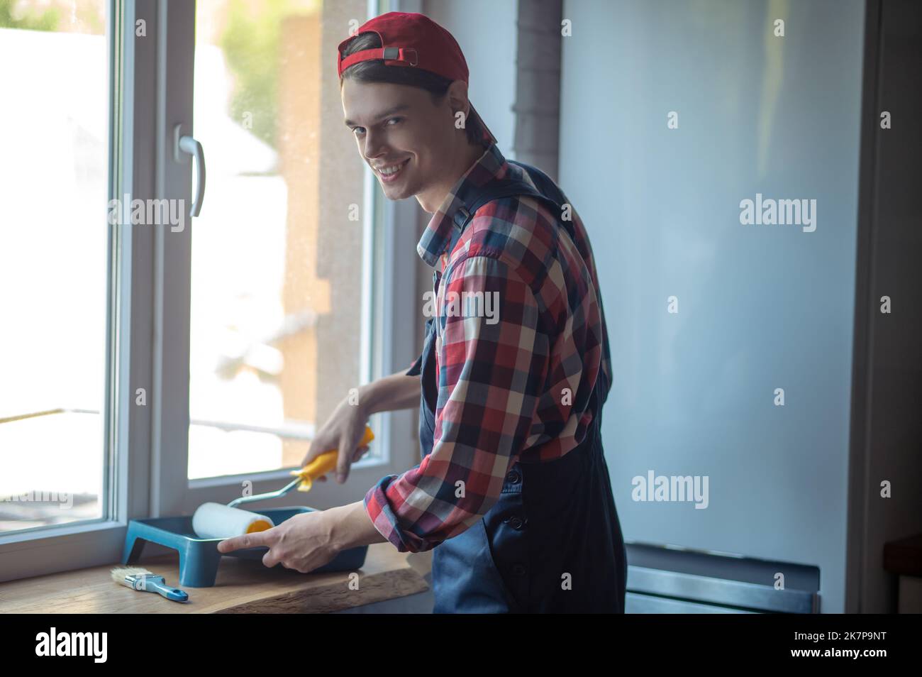 Cheerful worker getting ready for painting work Stock Photo