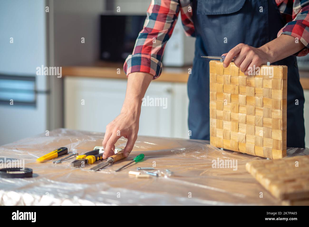 Experienced woodworker choosing a carpentry tool for work Stock Photo
