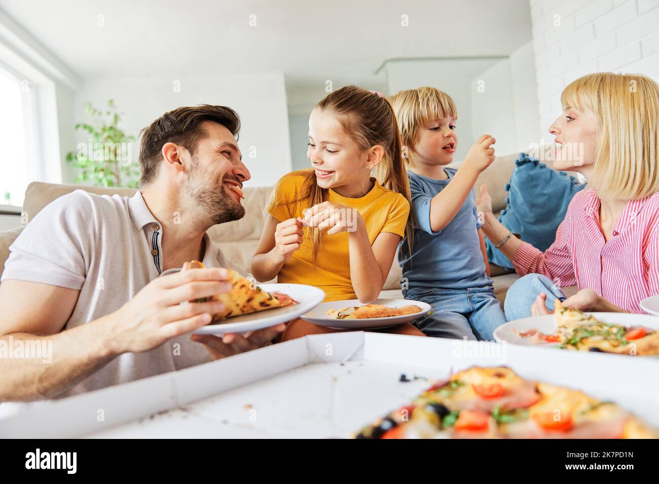 pizza family child food home eating son daughter mother father happy meal together lunch dinner man woman boy girl fun Stock Photo