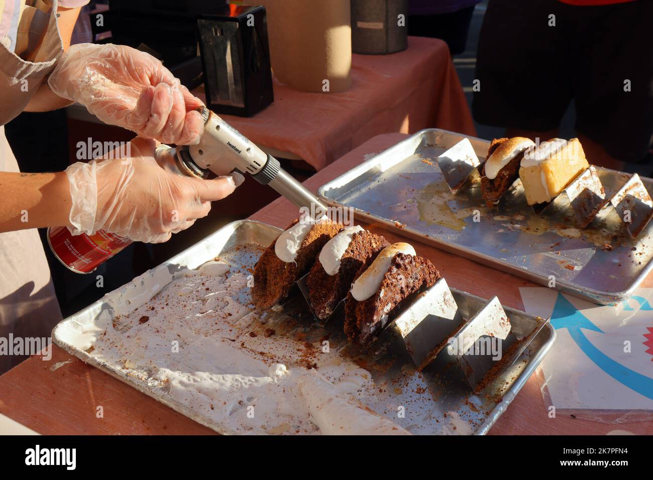 A worker from Creamery toasts the top of a marshmallow fluff
