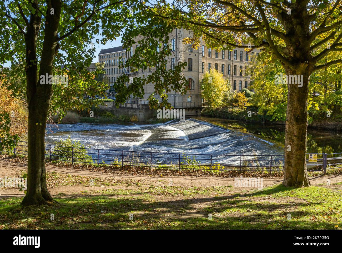 Salts Mill in Saltaire seen across the River Aire in West Yorkshire. Saltaire is a UNESCO World Heritage Site, Salts Mill is a converted textile mill. Stock Photo