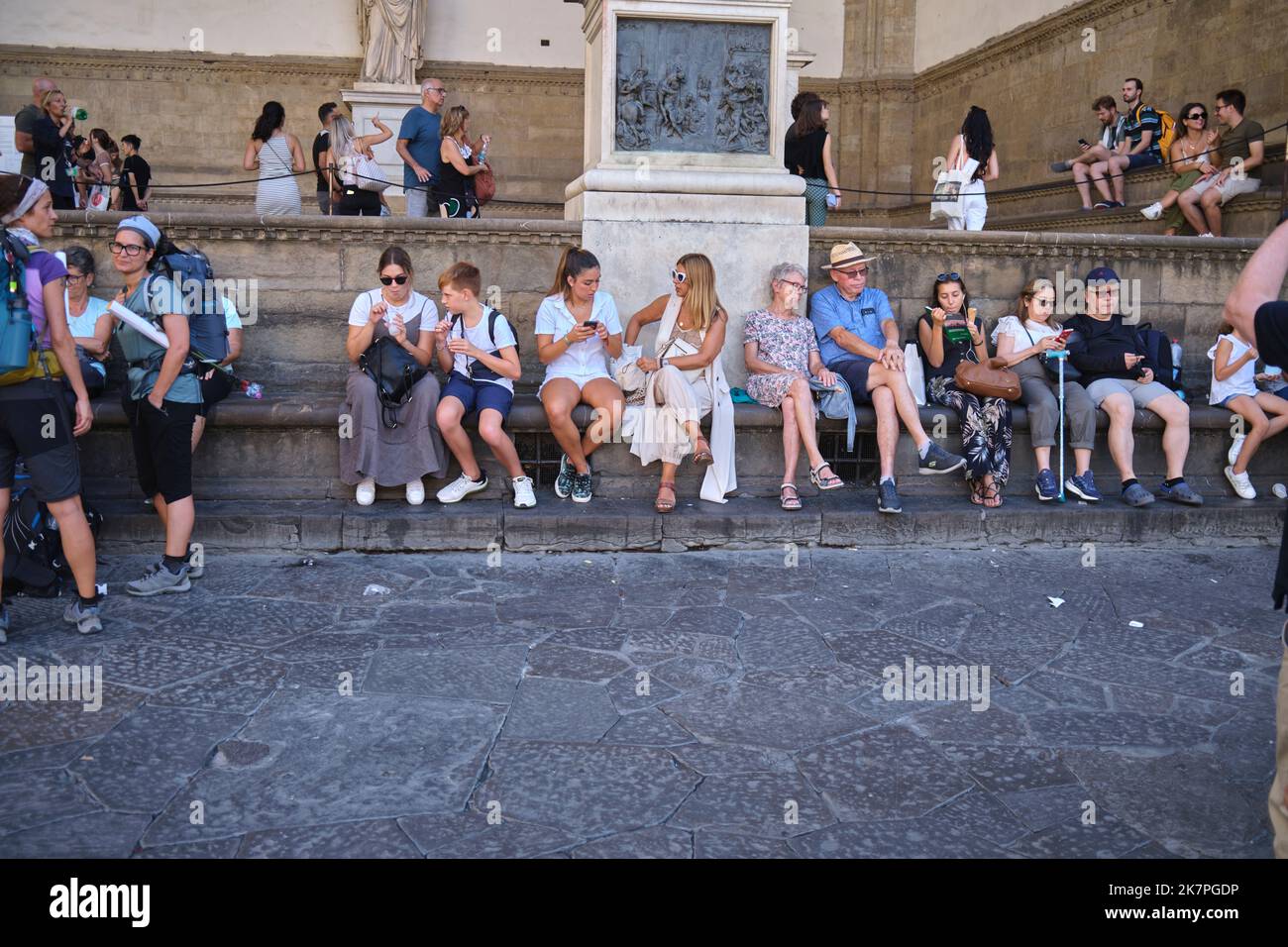 Tourists Sitting at the Base Loggia dei Lanzi  Florence Italy Stock Photo