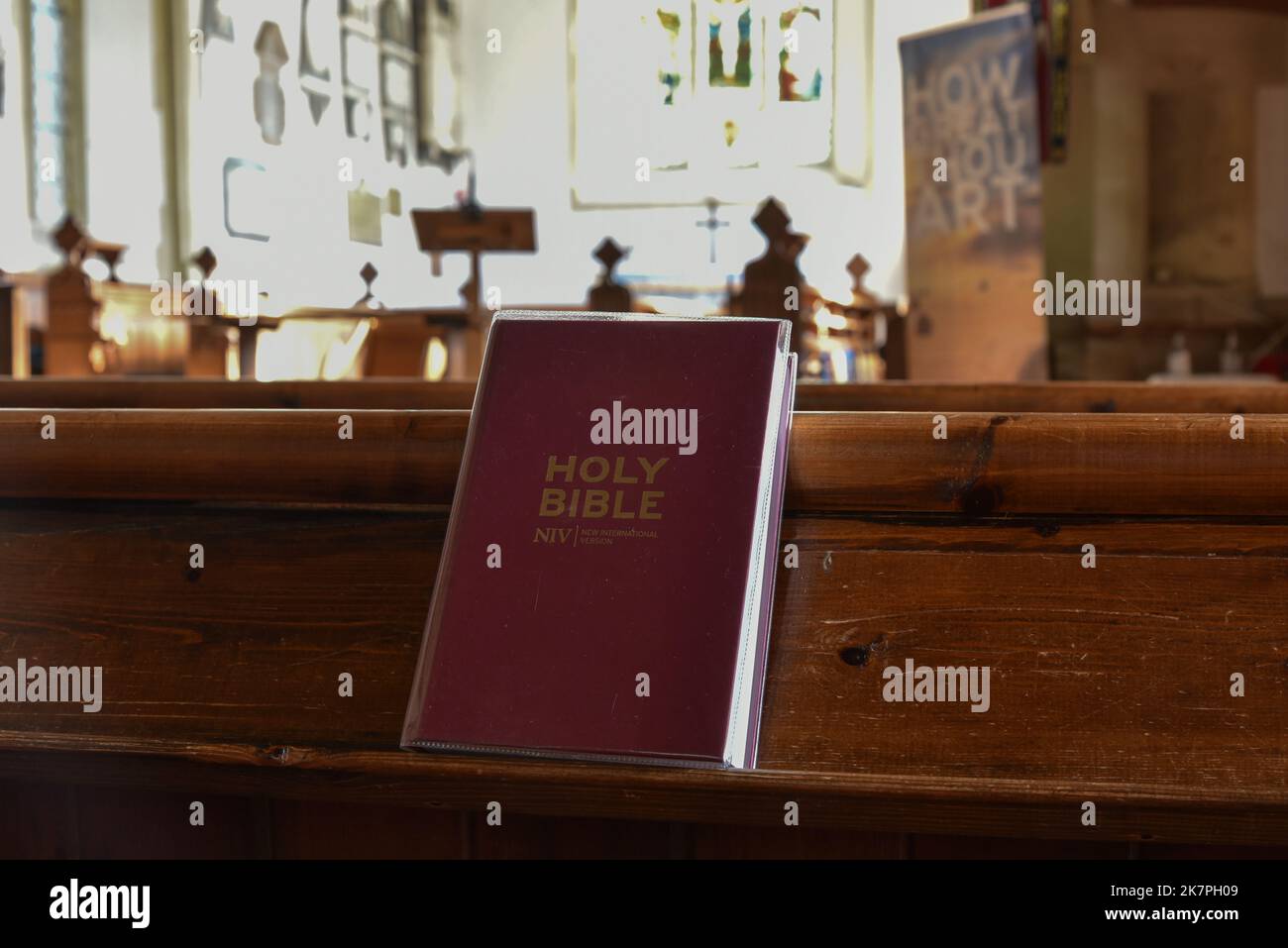 New International version bible on a pew inside an English church. Stock Photo