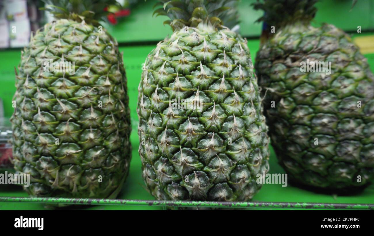 Fresh ripe organic pineapples are sold on the shelf in the local