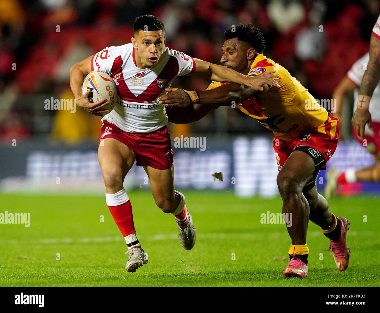 Tonga’s Soni Luke gets away from Papua New Guinea’s Nixon Putt during