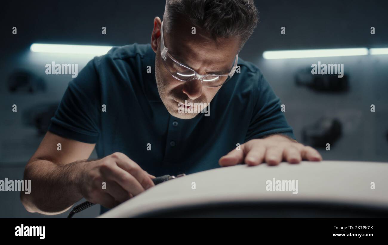 Experienced car designer works closely on the prototype car model in a ...