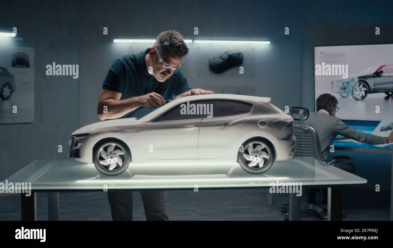 Senior automotive engineers work in high tech car manufacturing company