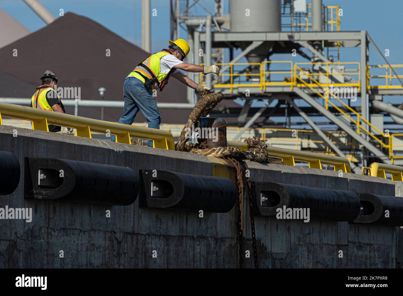 A dockworker dock the Amalia with cables in the Quebec city harbour on ...