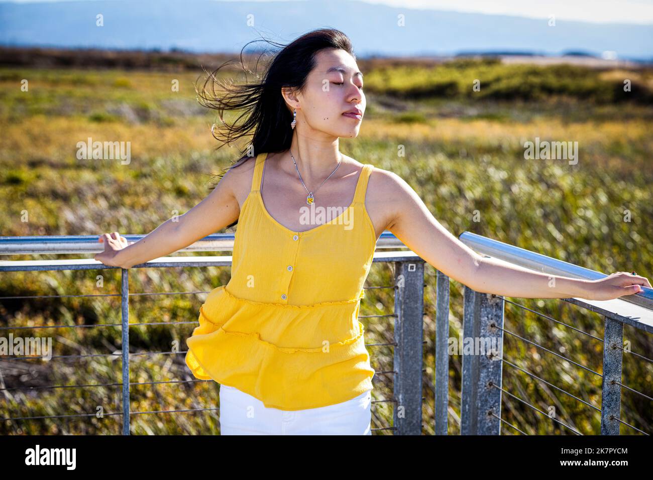 Portrait of Young Woman Standing on a Walkway in a Baylands Nature Preserve Stock Photo