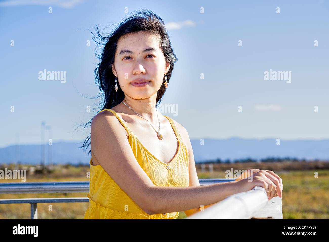 Portrait of Young Woman Standing on a Walkway in a Baylands Nature Preserve Stock Photo