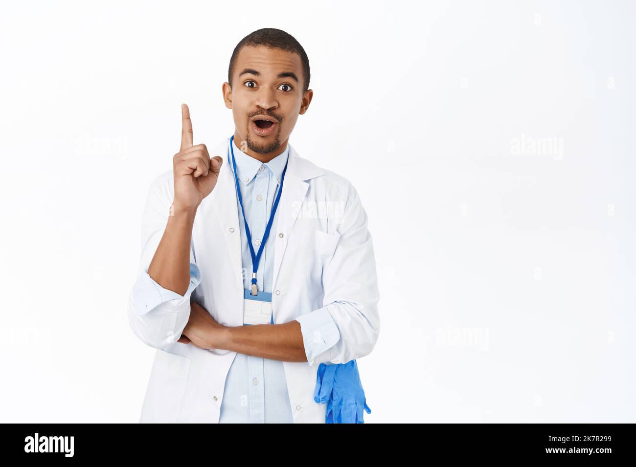 Arab doctor raise finger eureka gesture, saying suggestion, has an idea, standing over white background Stock Photo