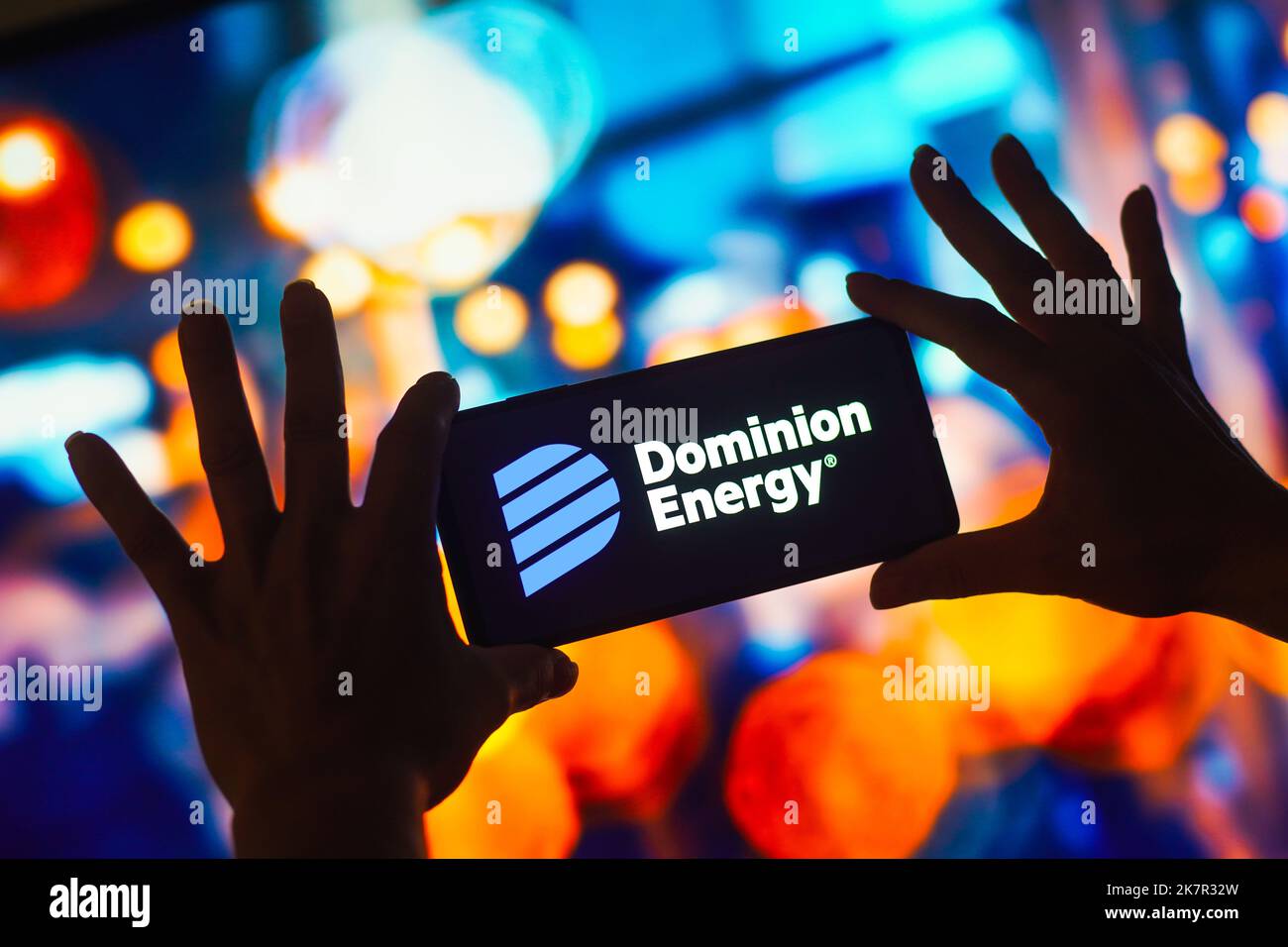 In this photo illustration, the Dominion Energy logo is displayed on a