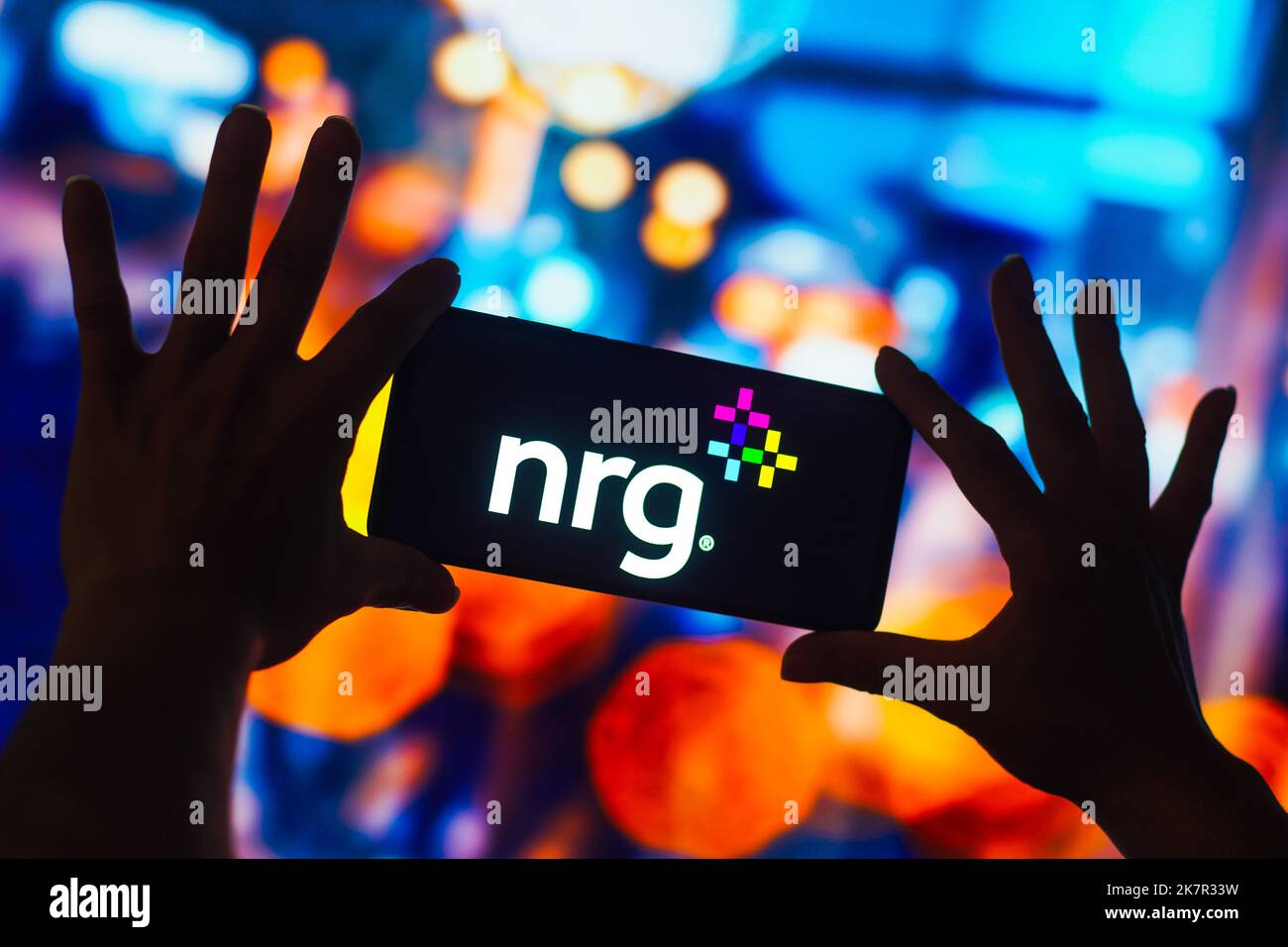 In this photo illustration, the NRG Energy logo is displayed on a ...
