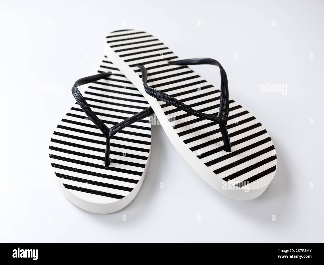 Pair of black and white stripe flip flops isolated on white background