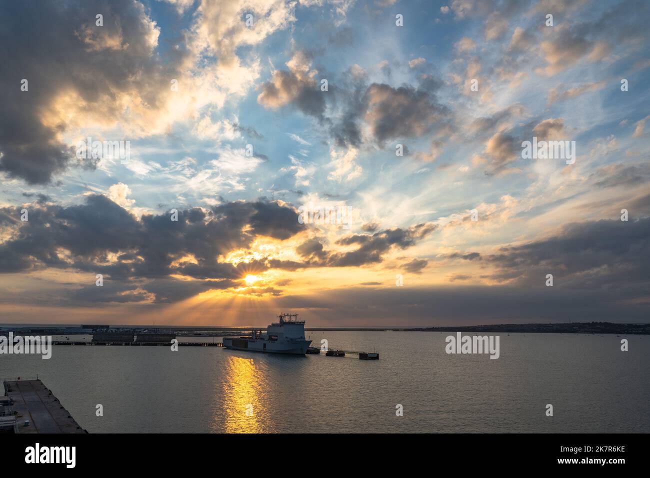 Sun rays through the clouds at sunset Stock Photo