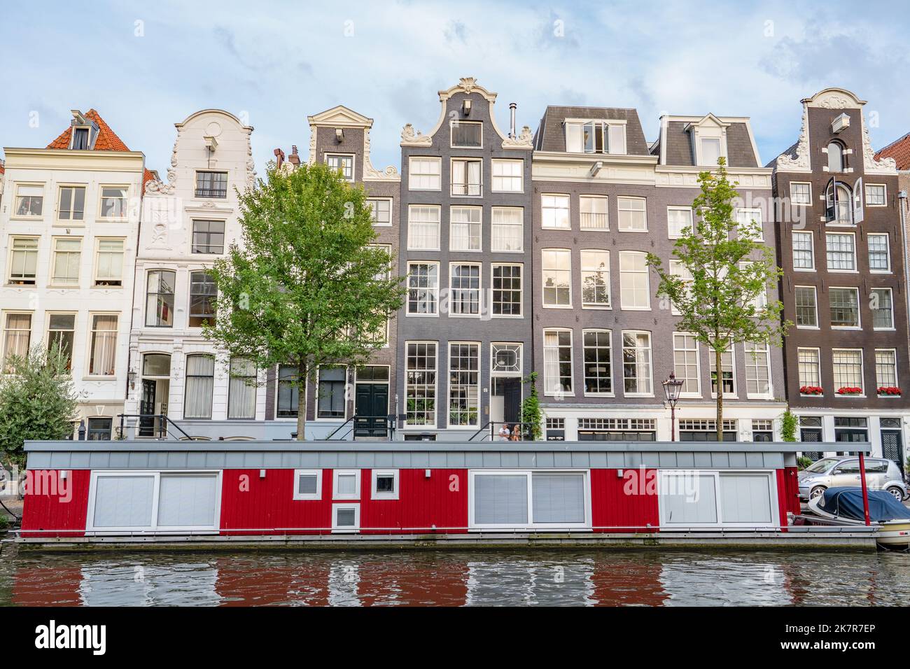 Beautiful canal houses stacked in a row in Amsterdam Stock Photo