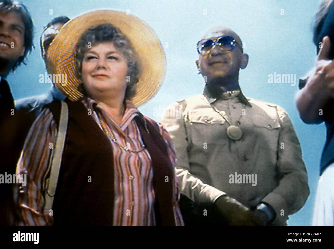 Shelley Winters, Telly Savalas Film: The French Atlantic Affair (1979) Characters: Helen Wabash,Father Craig Dunleavy  Director: Douglas Heyes 15 November 1979   **WARNING** This Photograph is for editorial use only and is the copyright of MGM and/or the Photographer assigned by the Film or Production Company and can only be reproduced by publications in conjunction with the promotion of the above Film. A Mandatory Credit To MGM is required. The Photographer should also be credited when known. No commercial use can be granted without written authority from the Film Company. Stock Photo
