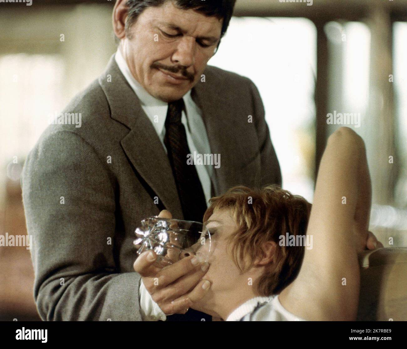 Charles Bronson & Marlene Jobert Film: Rider On The Rain (1970) Characters: Col. Harry Dobbs &  Director: Rene Clement 24 May 1970   **WARNING** This Photograph is for editorial use only and is the copyright of The Film Company and/or the Photographer assigned by the Film or Production Company and can only be reproduced by publications in conjunction with the promotion of the above Film. A Mandatory Credit To The Film Company is required. The Photographer should also be credited when known. No commercial use can be granted without written authority from the Film Company. Stock Photo