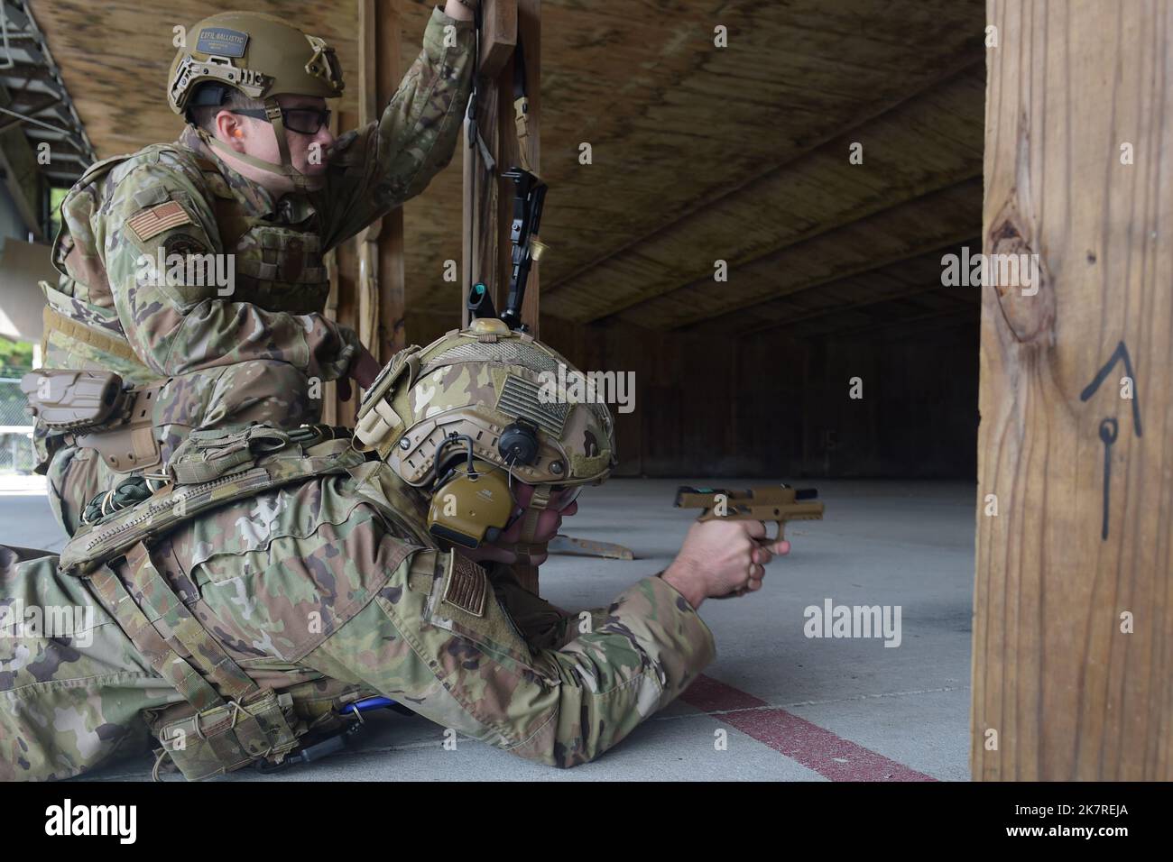 U.S. Air Force Senior Airman Kason Rondot, 822nd Base Defense Squadron armorer, fires M9 beretta at a ballistic pad alongside Staff Sgt. Mack Jones, 820th Combat Operations Squadron combat arms instructor, at Moody Air Force Base, Georgia, Sept. 27, 2022. Rondot and Jones shot 9 mm and 5.56 mm rounds at ballistic plates and Ballistic Rapid Air Deployable System (B-RADS) technology during a ballistic and blast protection demonstration.  (U.S. Air Force photo by Airman 1st Class Briana Beavers) Stock Photo