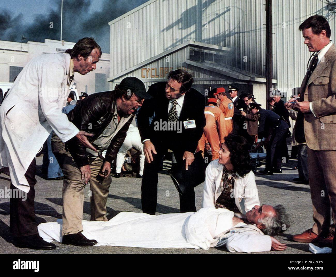 Ned Beatty, Stockard Channing & Larry Hagman Film: The Big Bus (USA 1976) Characters: Shorty Scotty,Kitty Baxter & Doctor in parking lot  Director: James Frawley 23 June 1976   **WARNING** This Photograph is for editorial use only and is the copyright of PARAMOUNT PICTURES and/or the Photographer assigned by the Film or Production Company and can only be reproduced by publications in conjunction with the promotion of the above Film. A Mandatory Credit To PARAMOUNT PICTURES is required. The Photographer should also be credited when known. No commercial use can be granted without written authori Stock Photo