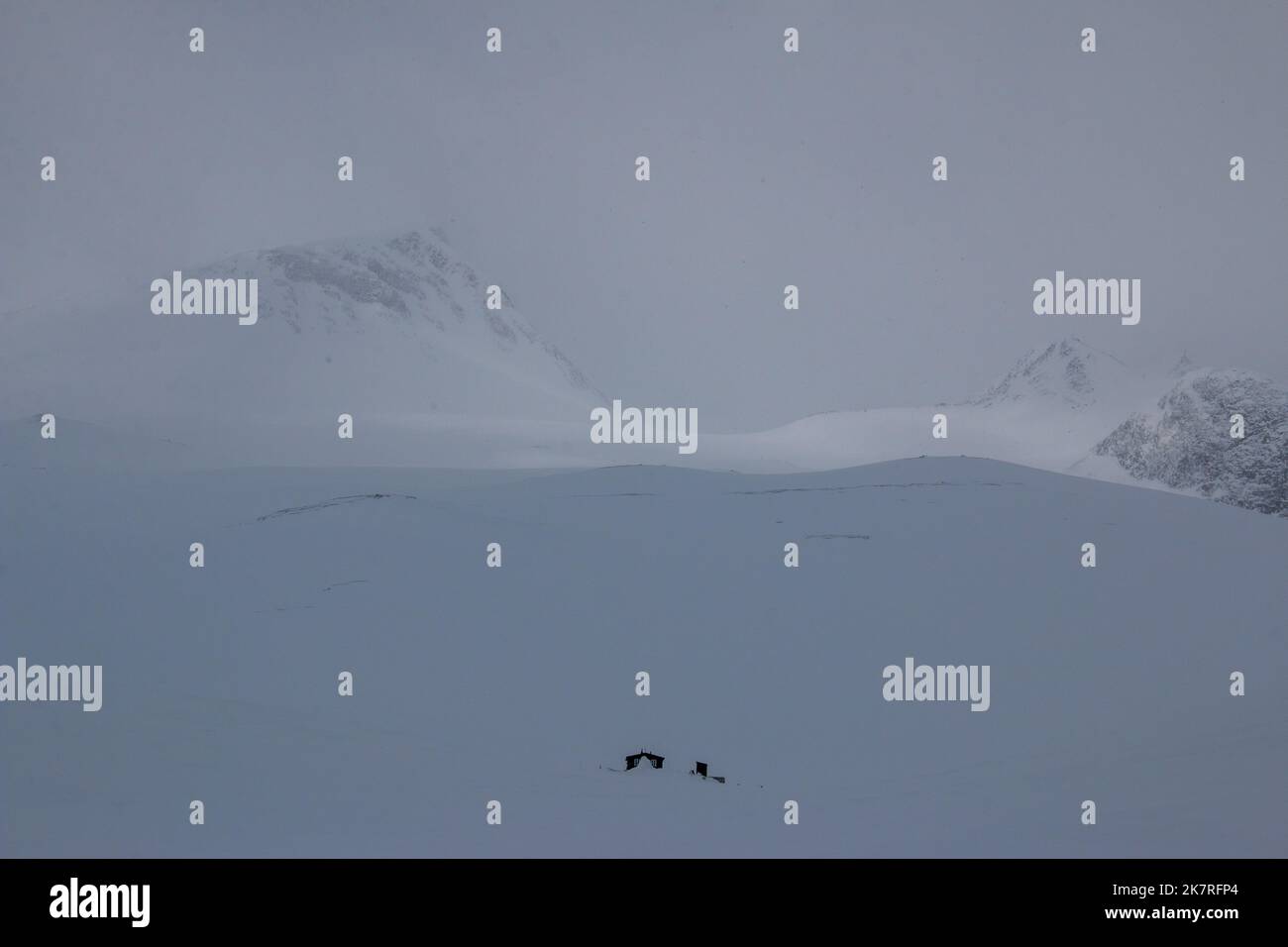 Nallo mountain hut covered in snow in a snowstorm, winter season, Lapland, Sweden Stock Photo