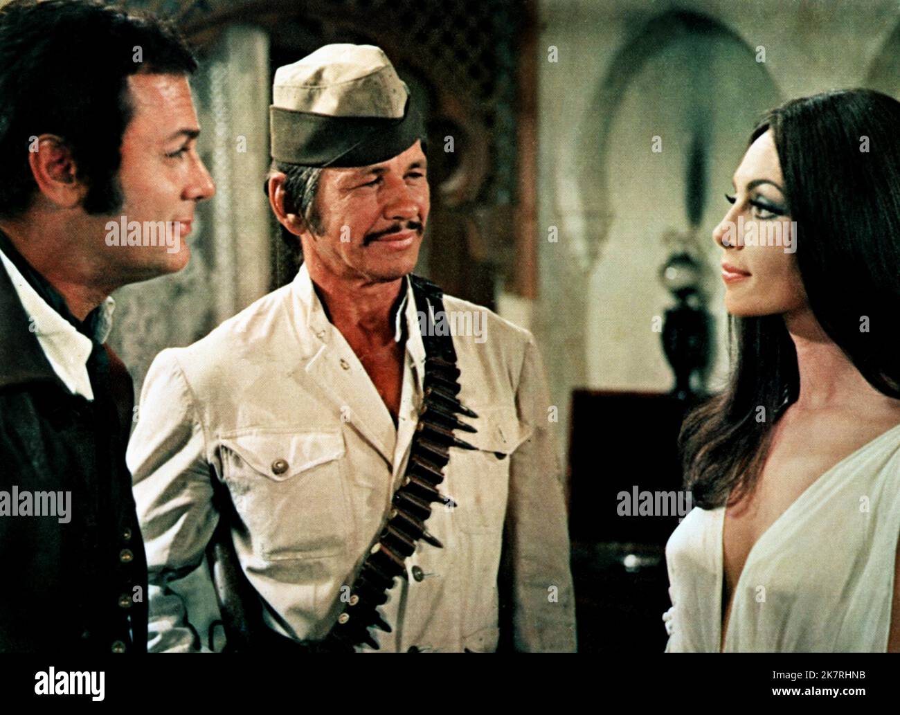 Tony Curtis, Charles Bronson & Michele Mercier Film: You Can'T Win 'Em All (1970) Characters: Adam Dyer,Josh Corey &  Director: Peter Collinson 24 July 1970   **WARNING** This Photograph is for editorial use only and is the copyright of COLUMBIA PICTURES and/or the Photographer assigned by the Film or Production Company and can only be reproduced by publications in conjunction with the promotion of the above Film. A Mandatory Credit To COLUMBIA PICTURES is required. The Photographer should also be credited when known. No commercial use can be granted without written authority from the Film Com Stock Photo