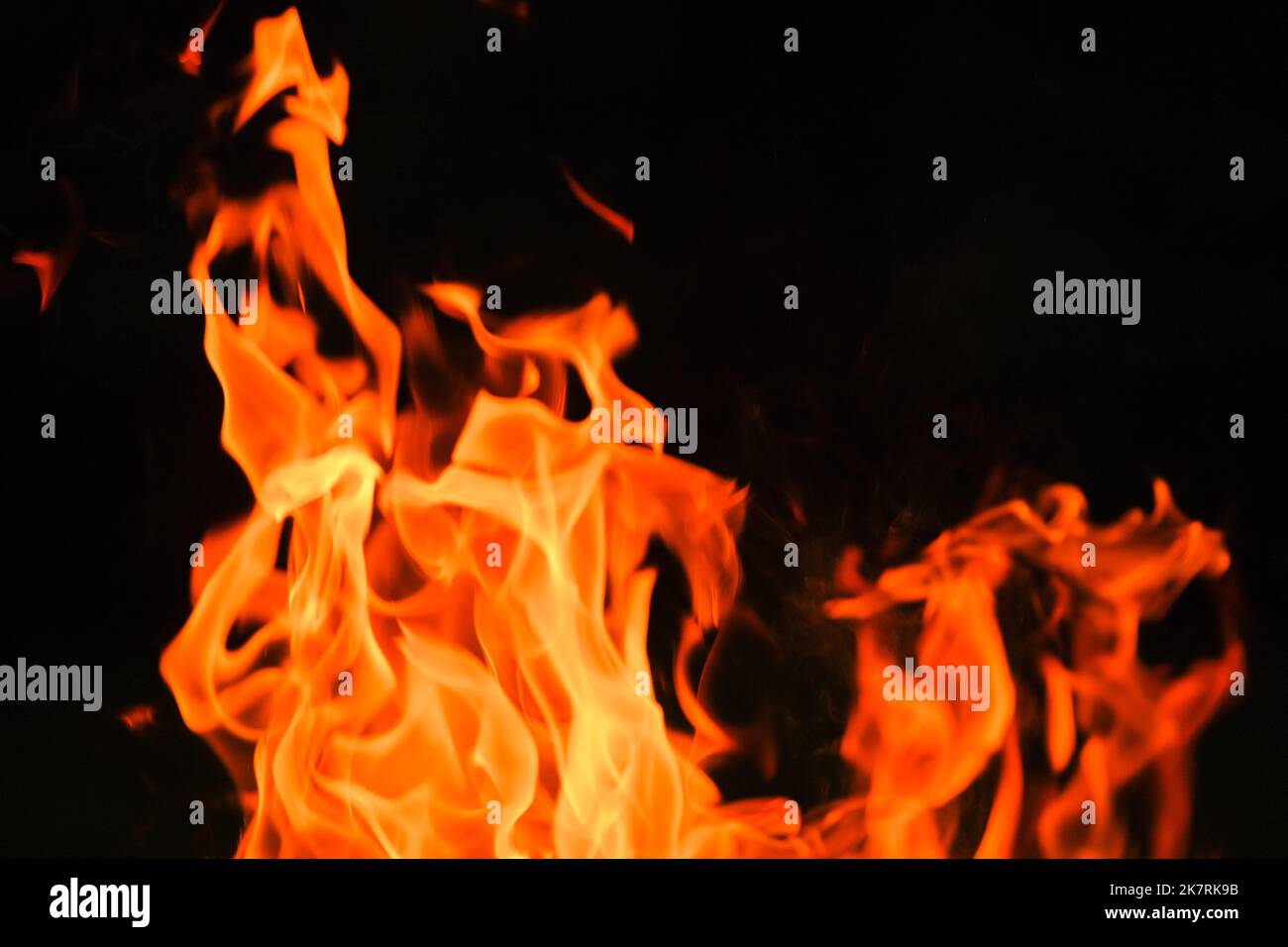 fiery wallpaper. Tongues of flame, sparks.Firewood burning in bonfire. Stock Photo