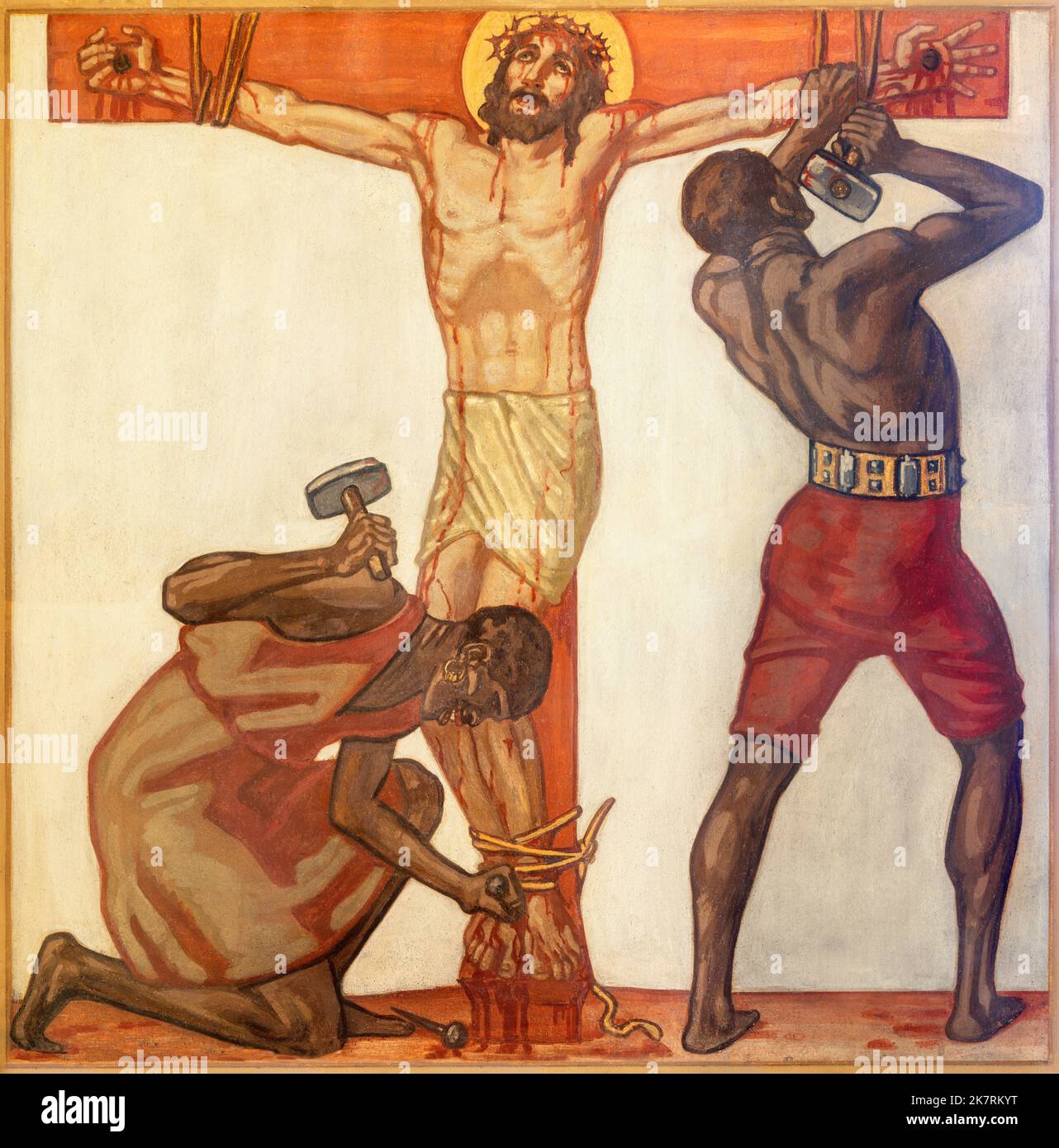 ZURICH, SWITZERLAND - JULY 1, 2022: The fresco  Jesus is nailed the the cross as the part of Cross way  of church St. Anton by Fritz Kunz (1921). Stock Photo