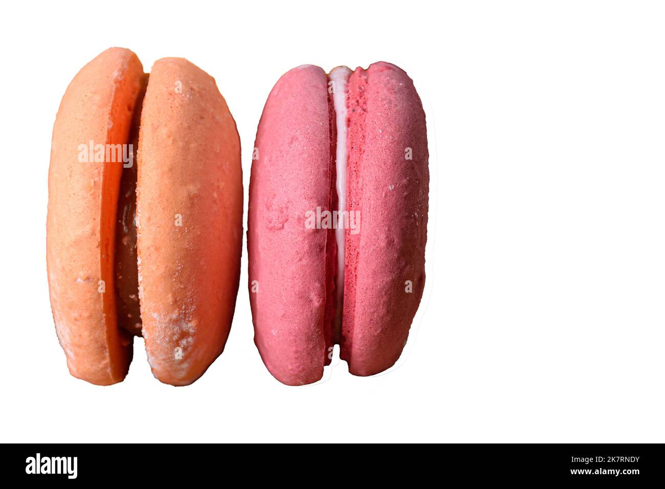 Closeup of two colored macarons vertically (white background). Stock Photo
