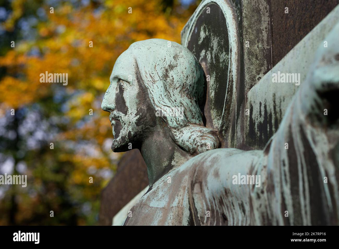 jesus sculpture in an autumn cemetery looks confidently to the future Stock Photo