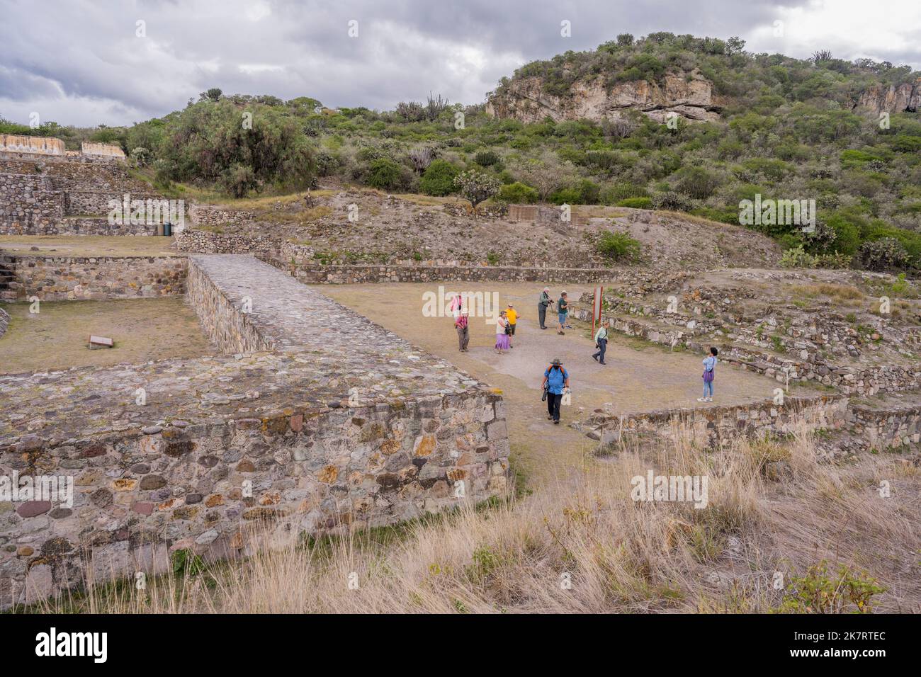 Tourists at the archaeological site of Yagul (known as Pueblo Viejo locally), once inhabited by the Pre-Columbian civilization of the Zapotecs, in the Stock Photo