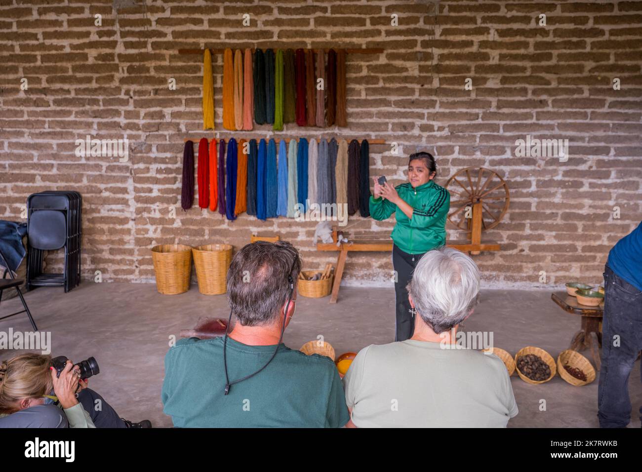 A weaver is explaining the dyeing of the wool at her home in Teotitlan del Valle, a small town in the Valles Centrales Region near Oaxaca, southern Me Stock Photo