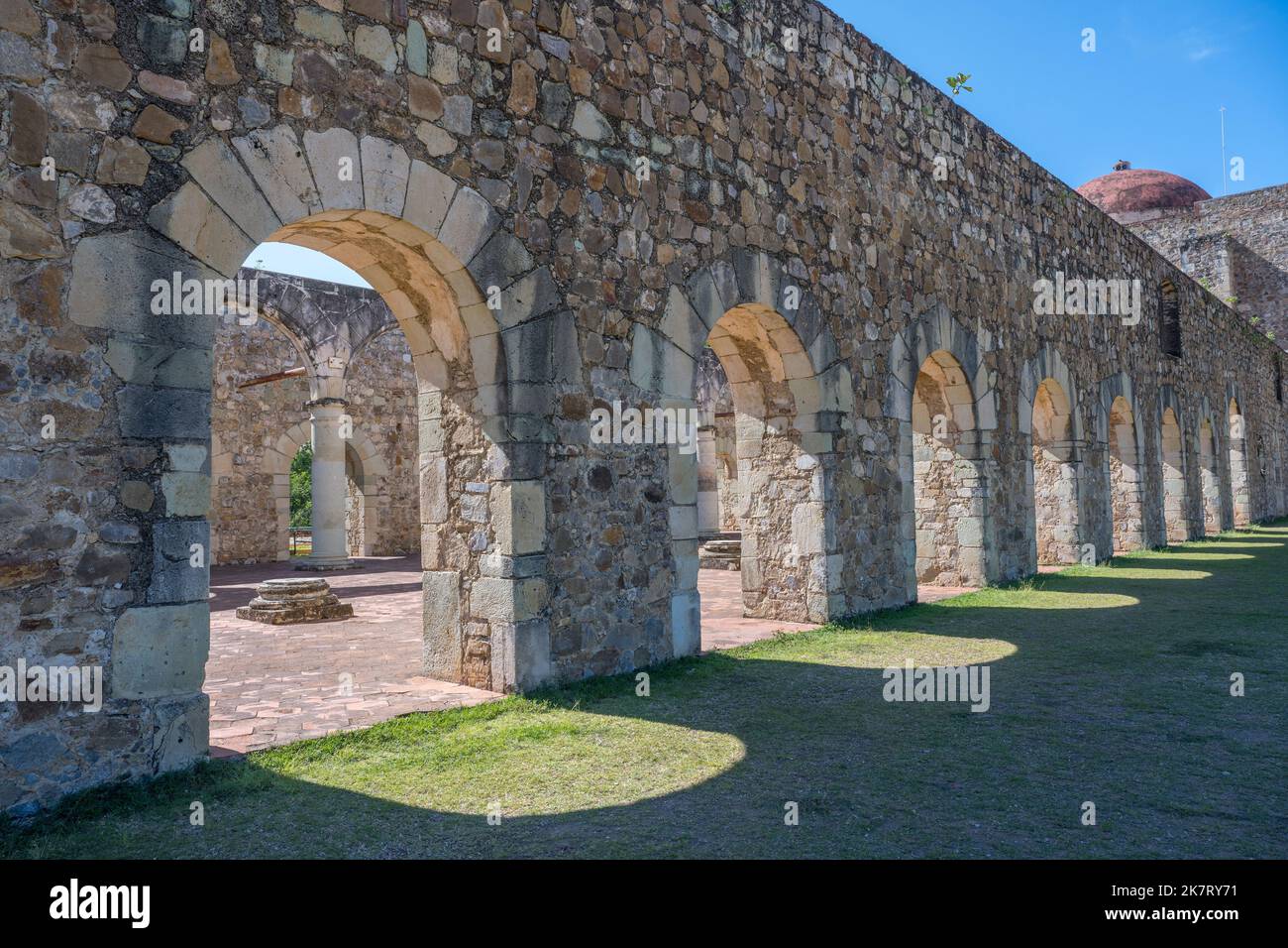 The sun is shining through the arches of the ancient roofless church of Cuilapan de Guerrero, a monastery built in the 16th century by the Spanish in Stock Photo