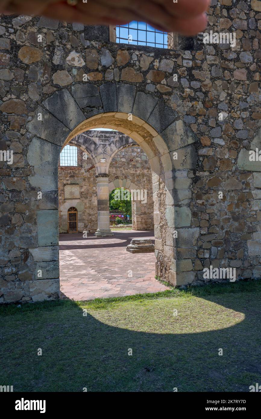The sun is shining through the arches of the ancient roofless church of Cuilapan de Guerrero, a monastery built in the 16th century by the Spanish in Stock Photo