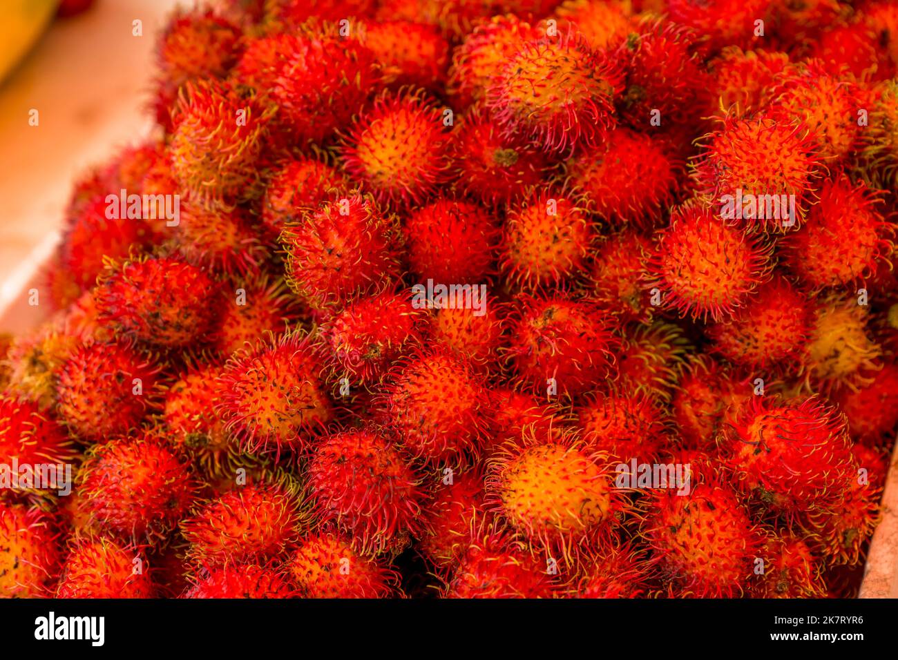 Rambutan fruits for sale on the weekly indigenous market in the small town of Zaachila near Oaxaca City, Mexico. Stock Photo