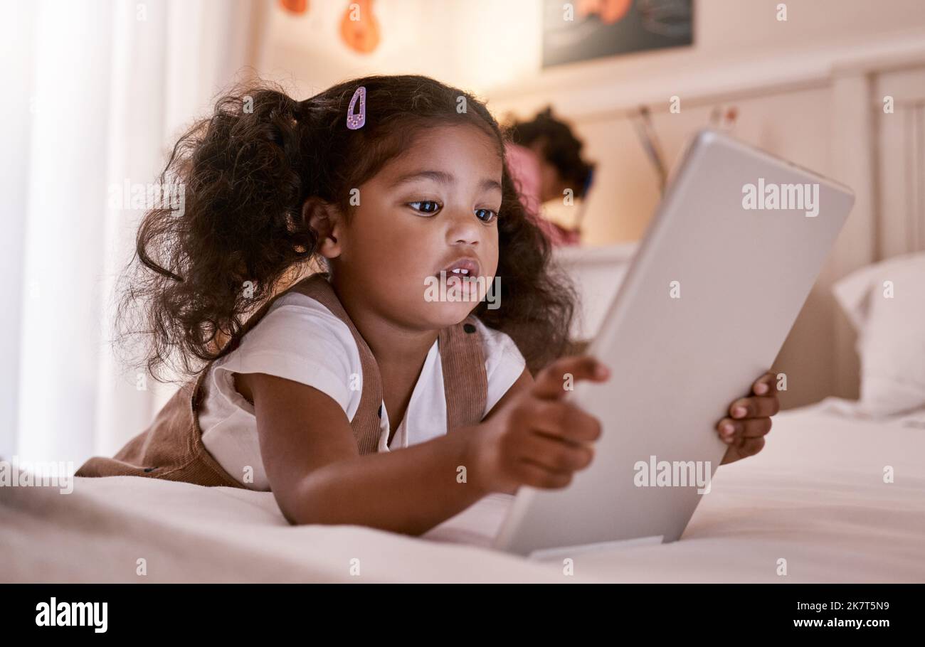 Technology can even make tiny lives easier. a little girl using a