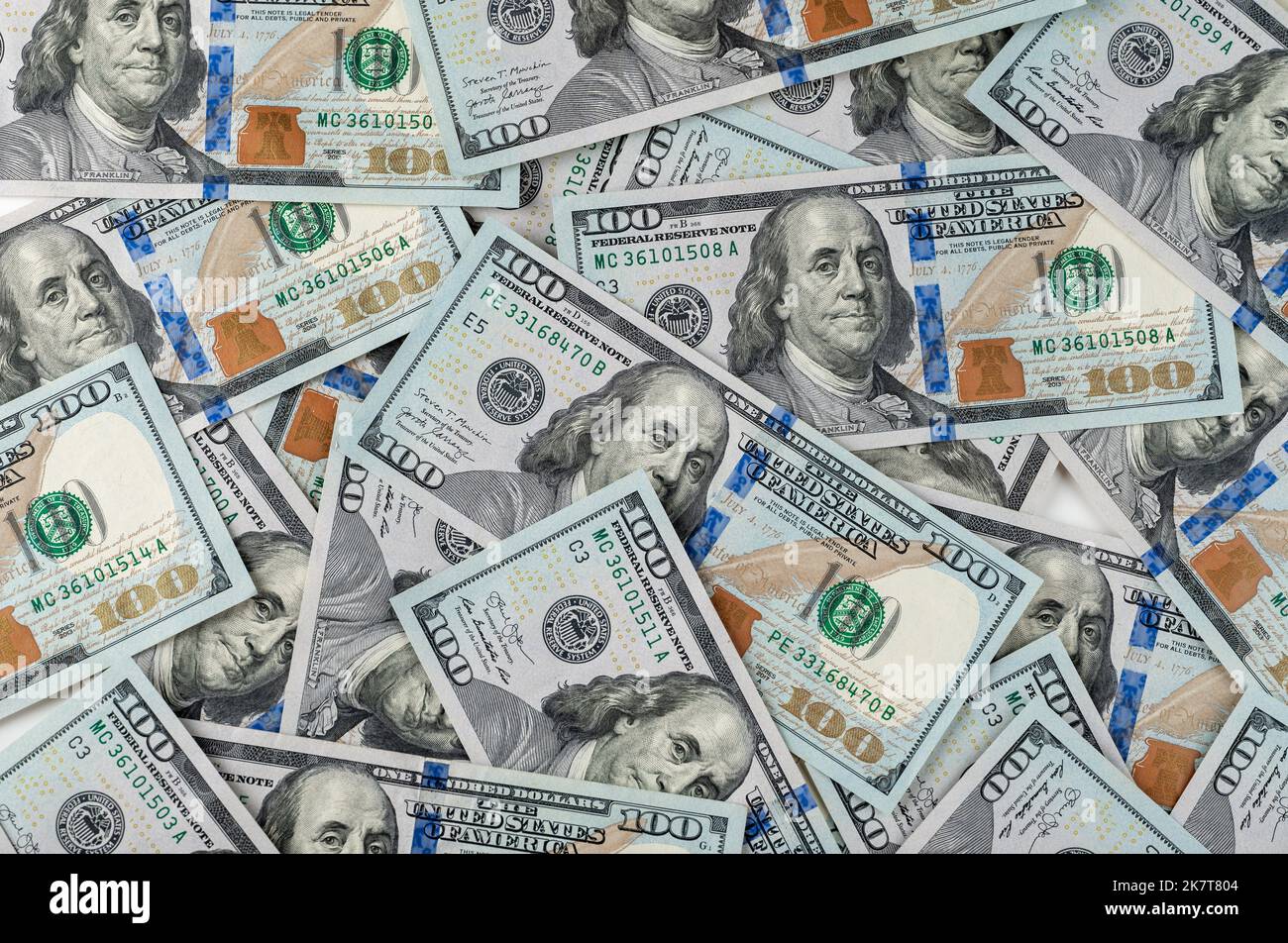 pile of one hundred US banknotes. Background with money american hundred dollar bills. 100 bills background. Lots of dollar bank notes on the table Stock Photo