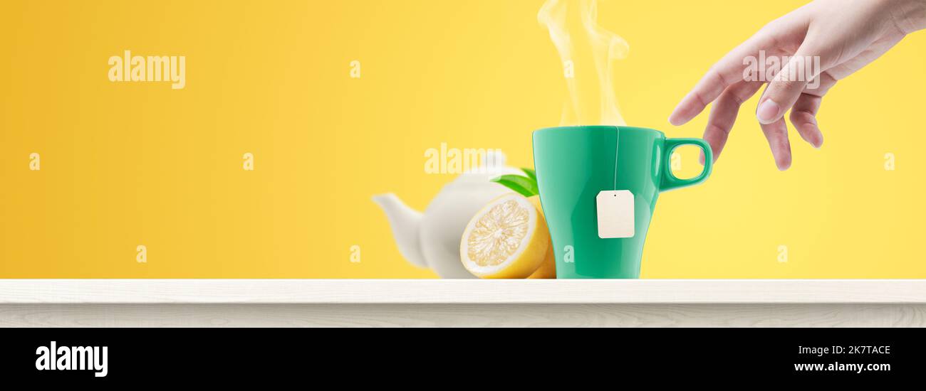 Woman having a tea break, she is taking a cup of tea, banner with copy space Stock Photo