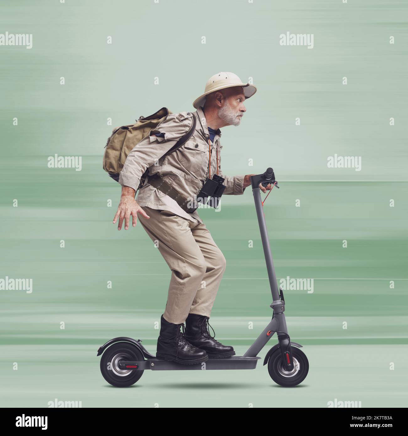 Funny explorer tourist travelling and riding a fast electric scooter Stock Photo