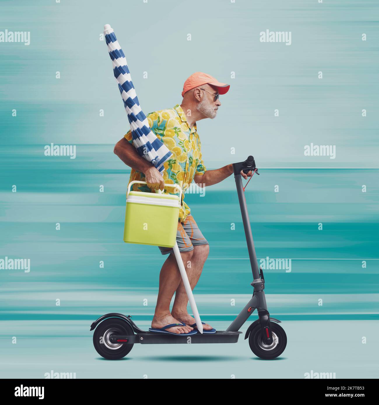 Funny senior tourist holding a beach umbrella and riding a fast electric scooter Stock Photo Alamy