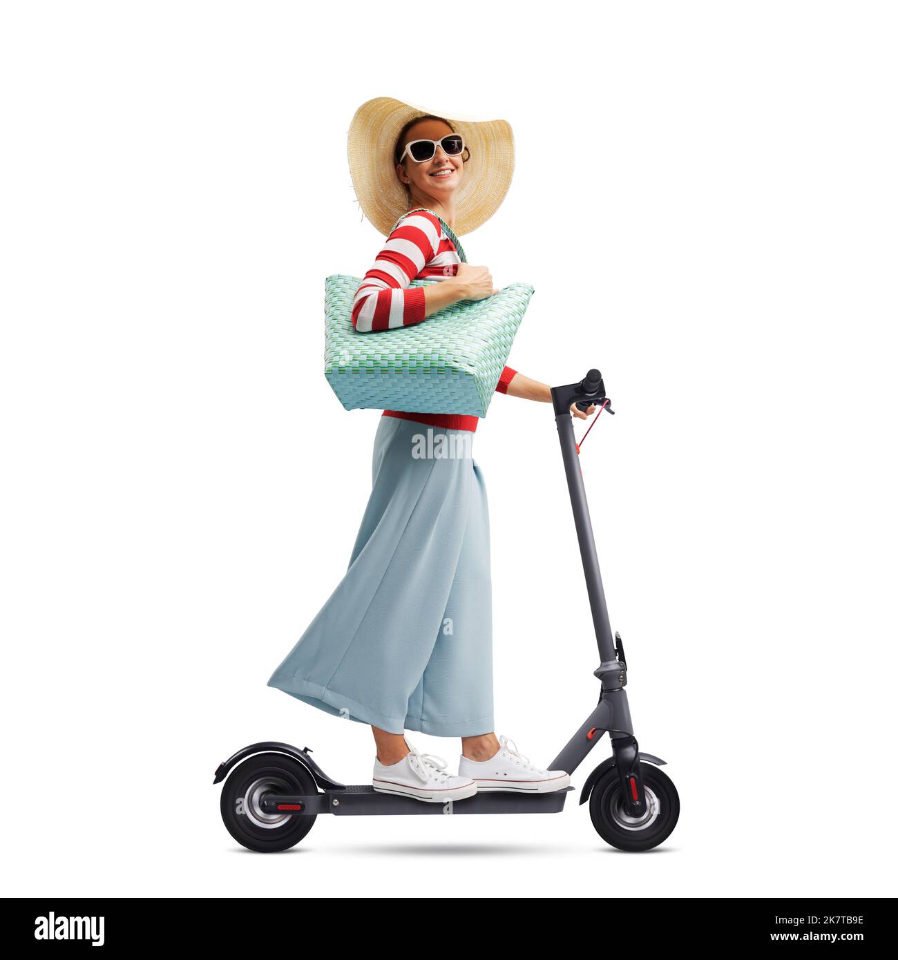 Happy fashionable woman riding an eco-friendly electric scooter, smart mobility concept Stock Photo