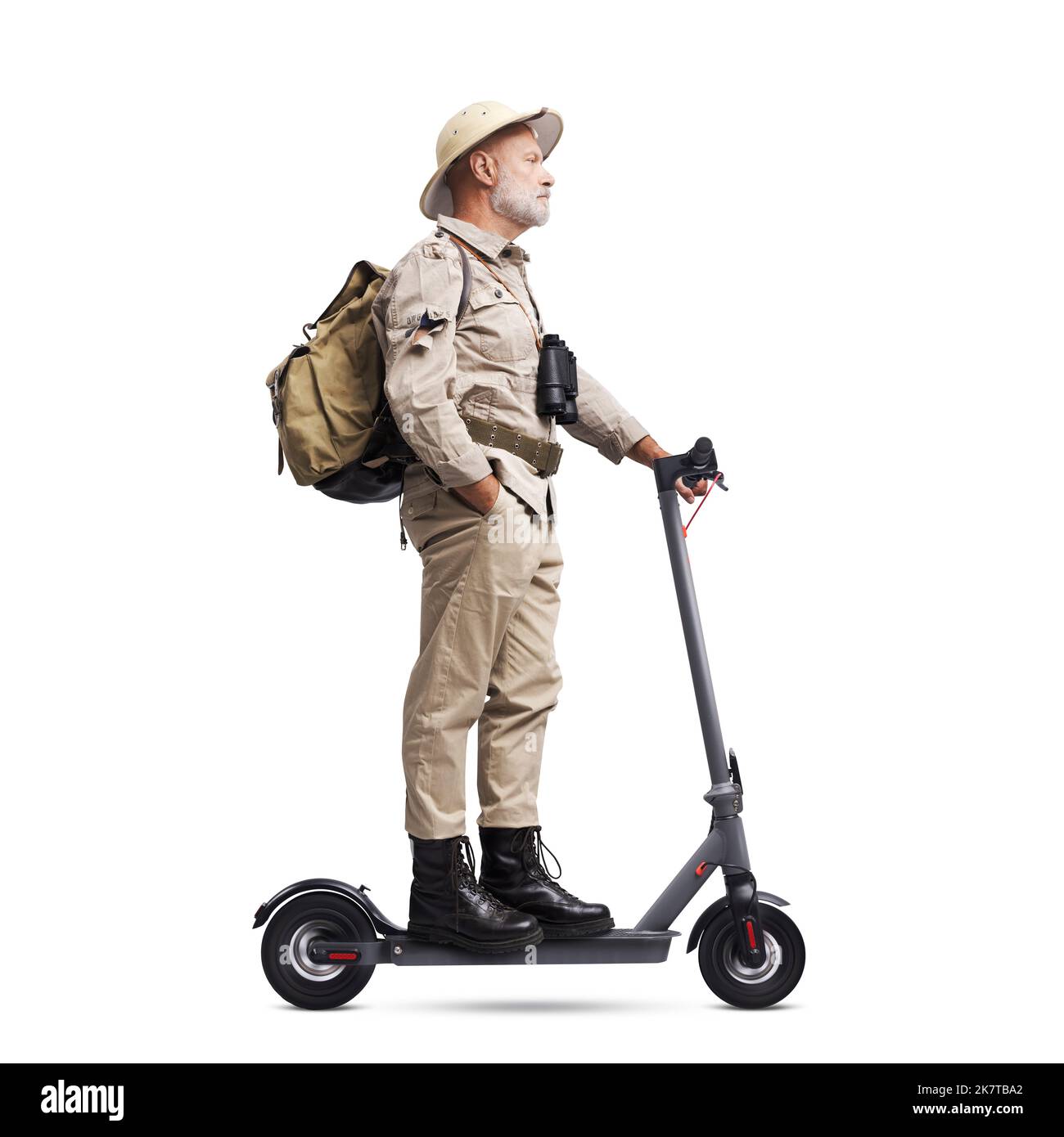 Confident vintage style explorer riding an electric scooter, isolated on white background Stock Photo