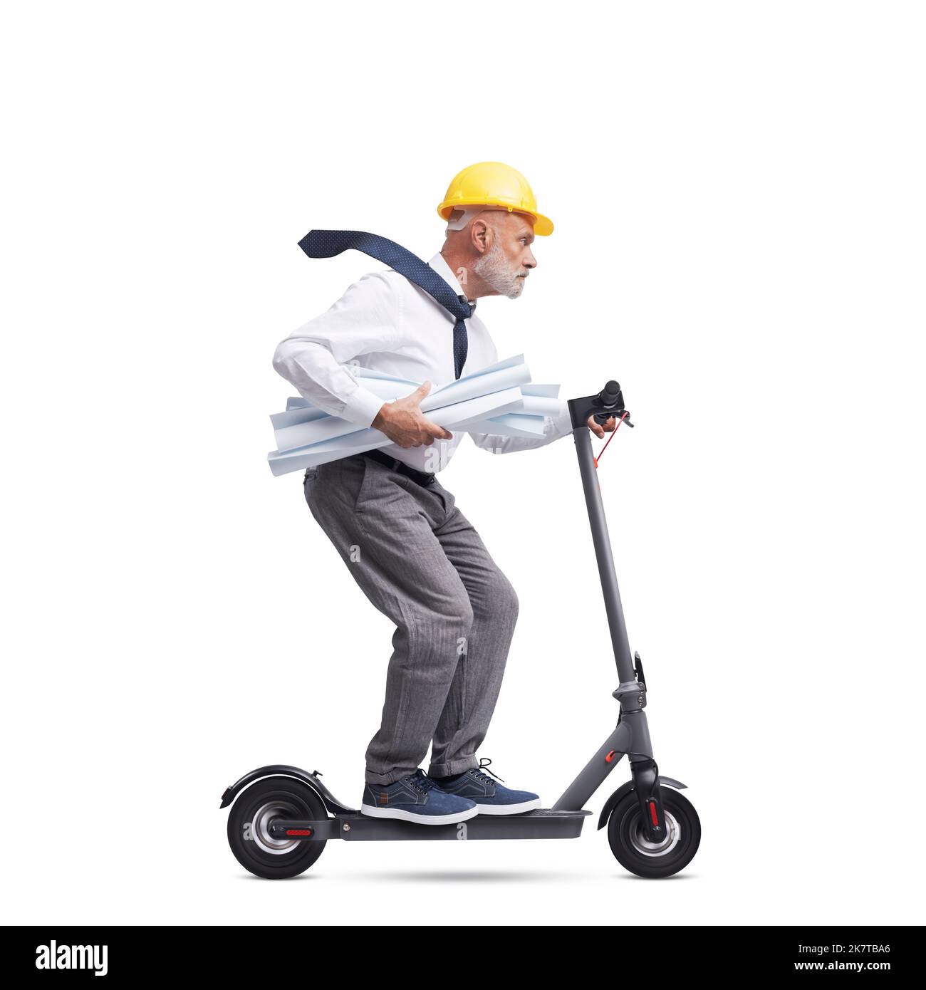 Professional senior architect wearing a safety helmet and riding an electric scooter, isolated