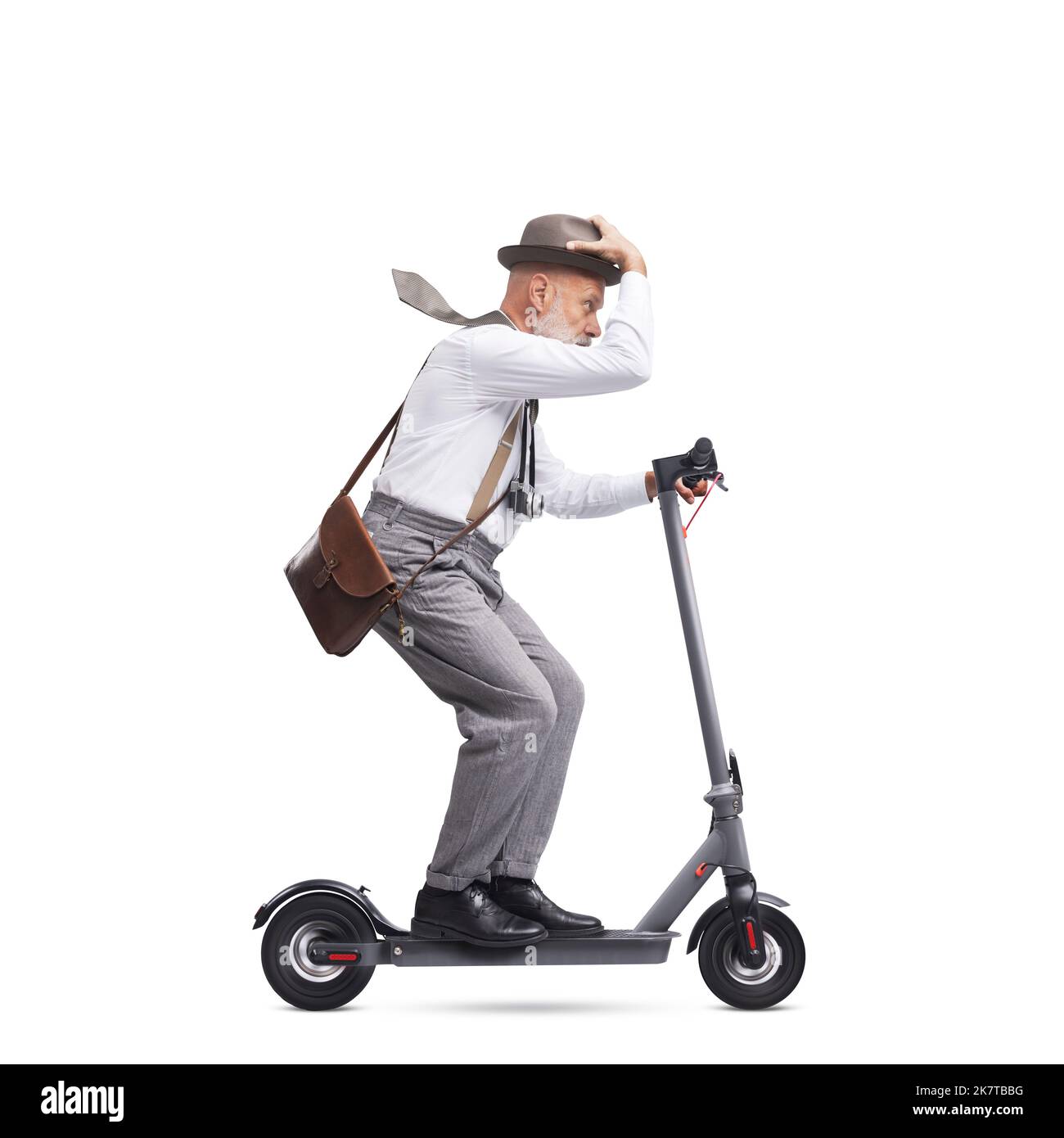 Confident vintage style photographer with hat riding a fast scooter, isolated on white background Stock Photo