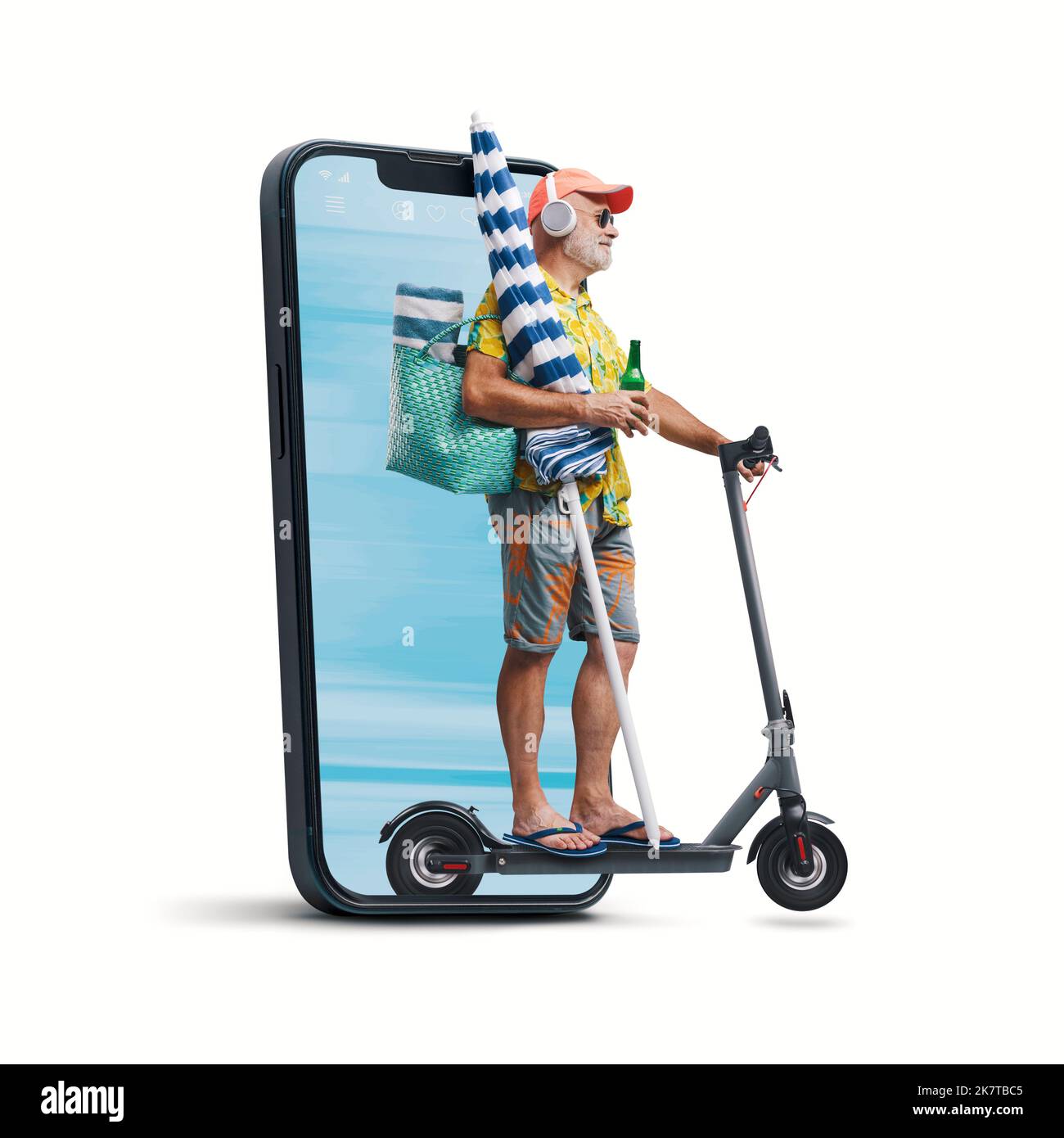 Funny senior tourist riding an electric scooter and going to the beach, he is coming out from a smartphone screen, isolated on white background Stock Photo