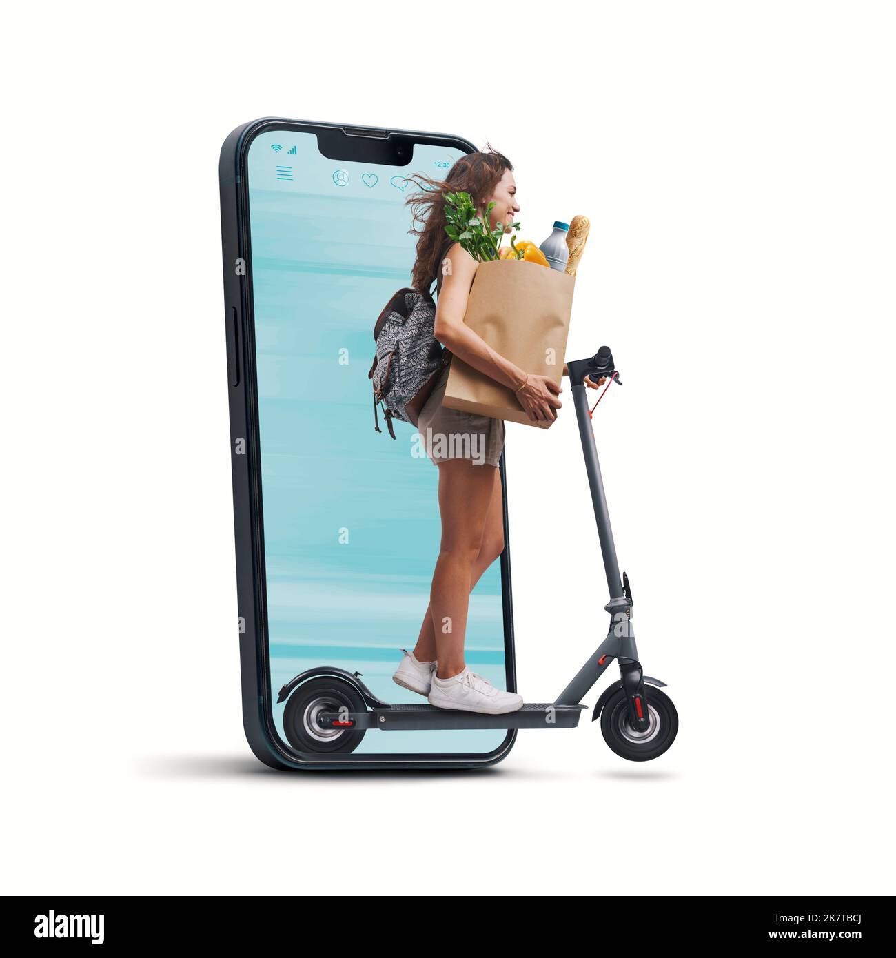 Woman holding a paper bag with groceries and riding an electric scooter, she is coming out from a smartphone screen, online grocery shopping concept Stock Photo