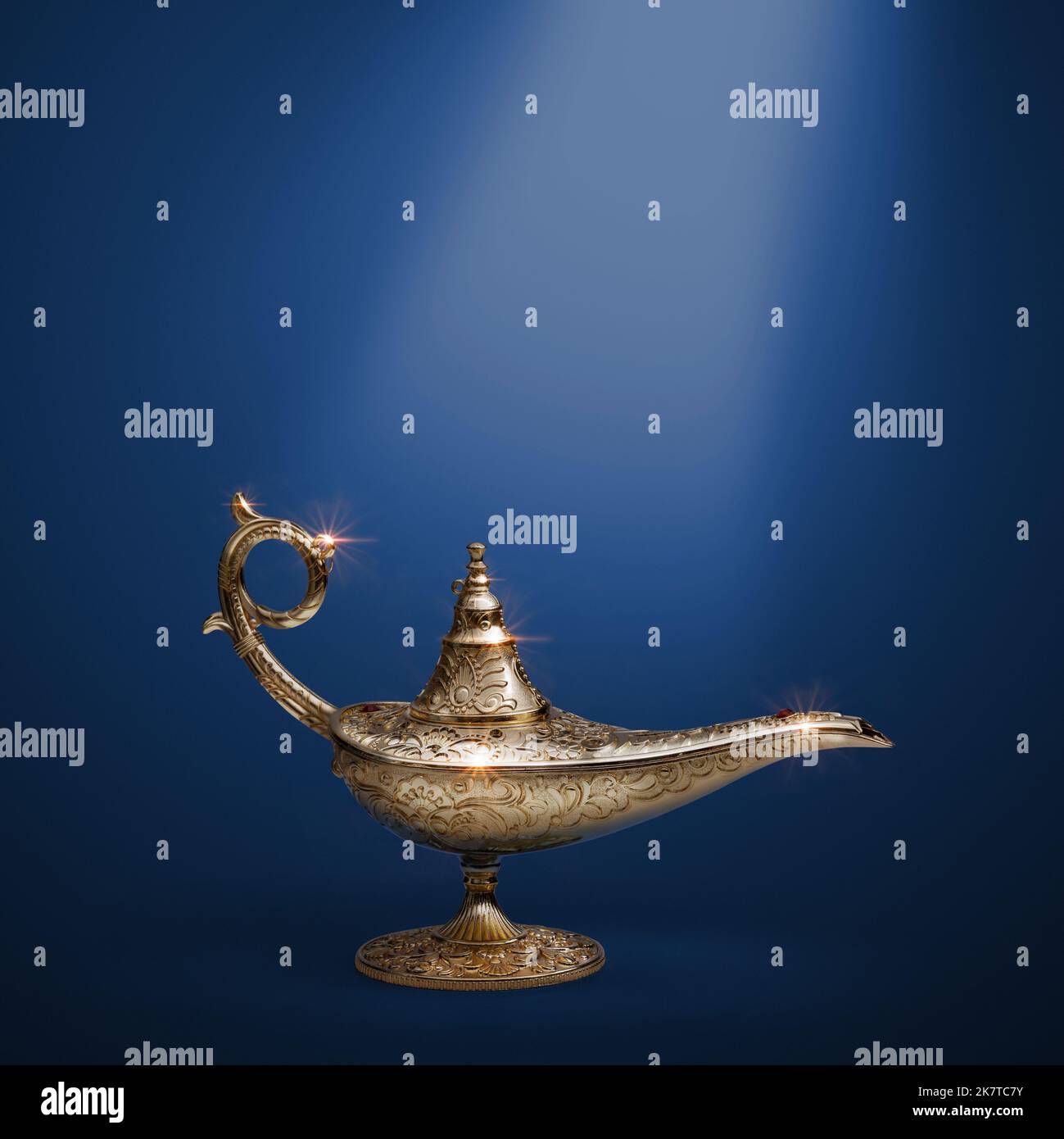 Precious golden magic lamp on blue background, fairy tales and wish fulfillment concept Stock Photo