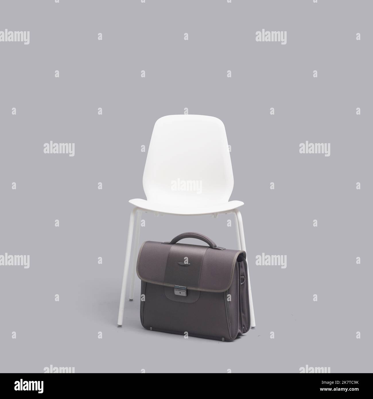 Empty chair in a waiting room and briefcase, job interview concept Stock Photo